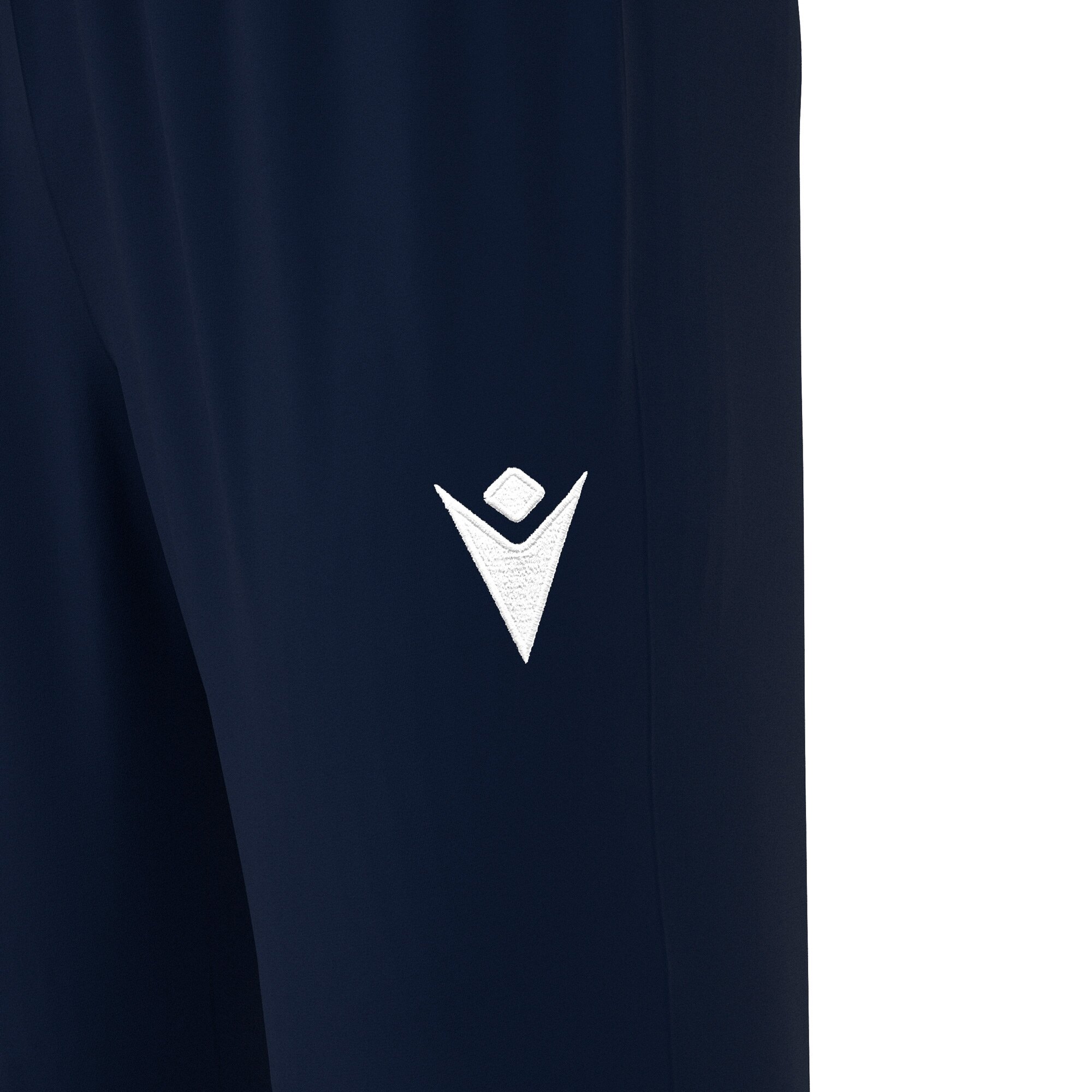 Frontal view of the Macron hero logo embroidered in white on the left thigh of the Neckar tracksuit bottoms for PE in navy.