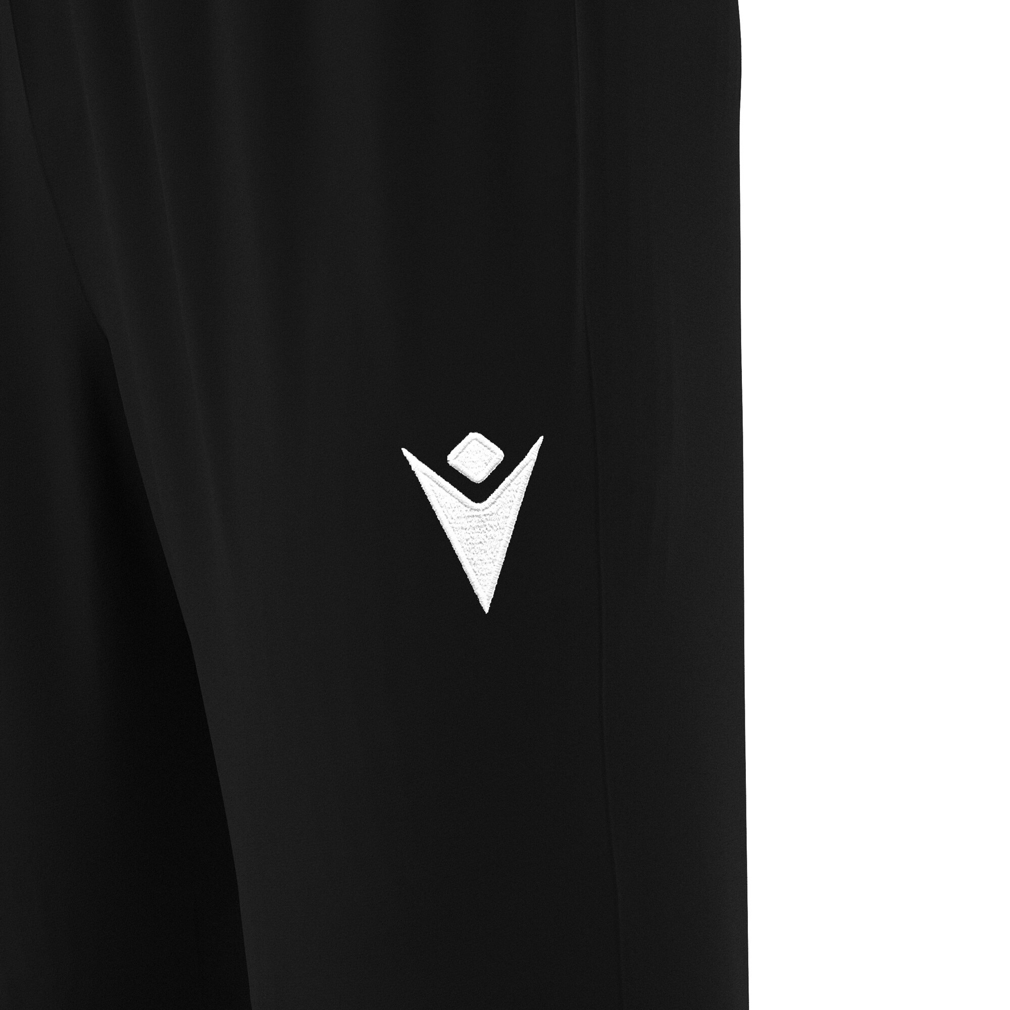 Frontal view of the Macron hero logo embroidered in white on the left thigh of the Neckar tracksuit bottoms for PE in black.