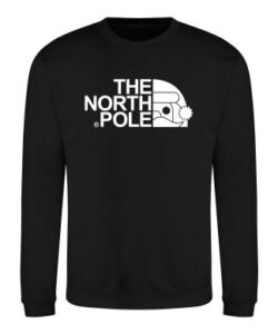 Frontal view of the "North Pole" Christmas sweatshirt: a black sweatshirt in front of white background. Printed to the front is white text that reads "THE NORTH POLE". Alligned next to the text is a half Santa face wearing a Christmas hat - all in white.