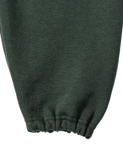 Close-up view of an elasticated leg end on on bottle-green jogging bottoms