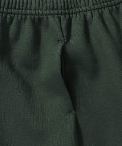 Close-up view of a side pocket on bottle-green jogging bottoms