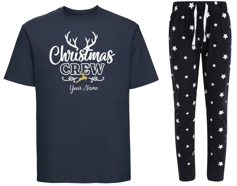 A navy printed t-shirt next to navy pyjama bottoms covered in stars. The print to the t-shirt is text that reads "Christmas Crew" and sample text "your name". The word: "Christmas" is in cursive solid white. The word "crew" is block capital outlines. The sample "your text" is in a solid white cursive font. Behind the word "Christmas" are white antlers reaching up. Between the texts "crew" and "your name" are two curley white lines with a golden reindeer betweem them.