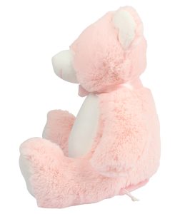 Side view of a baby pink teddy bear against a white background.
