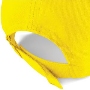 Close up view of the adjuster on the back of a yellow cap.