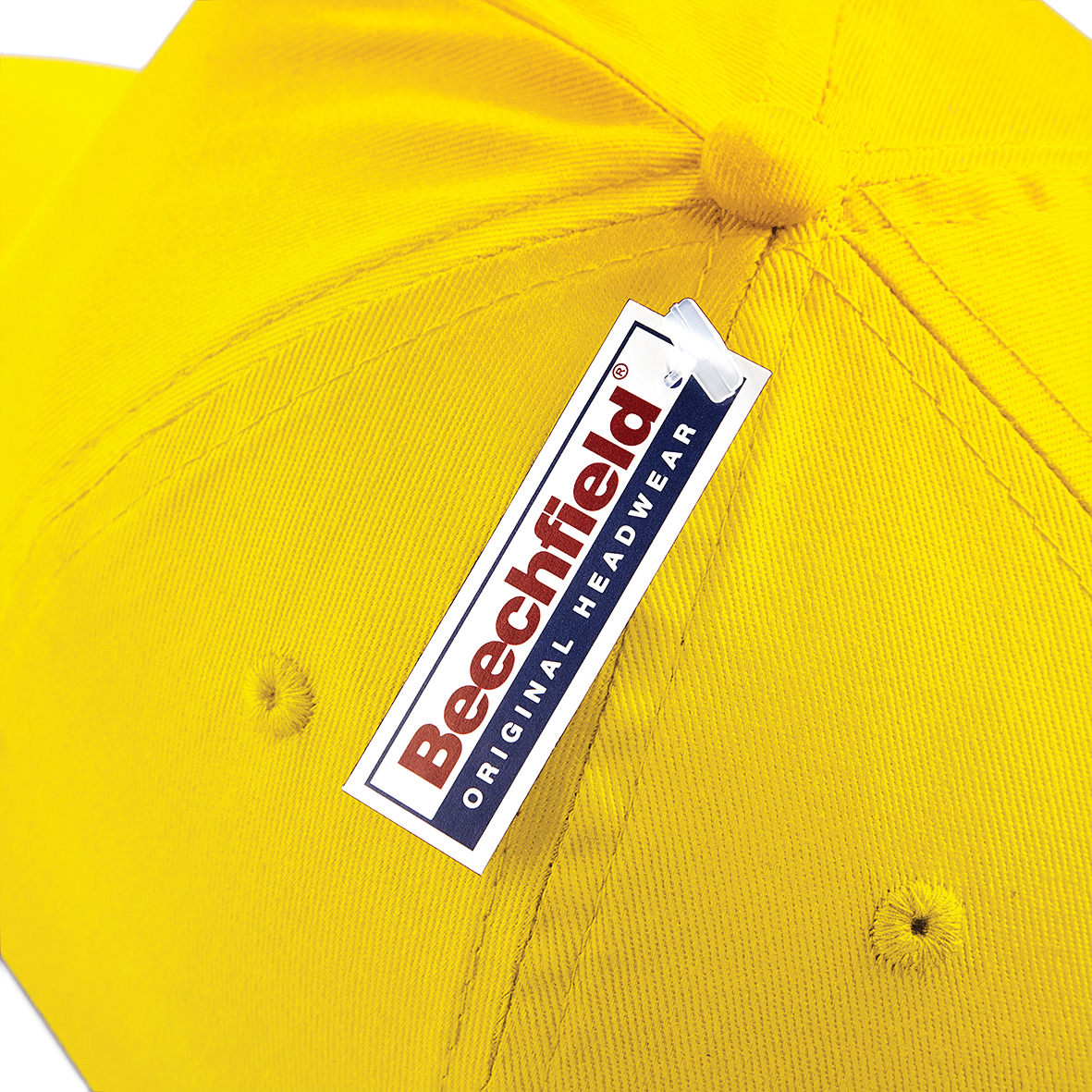 Close up view of a Beechfield tag on a yellow cap.