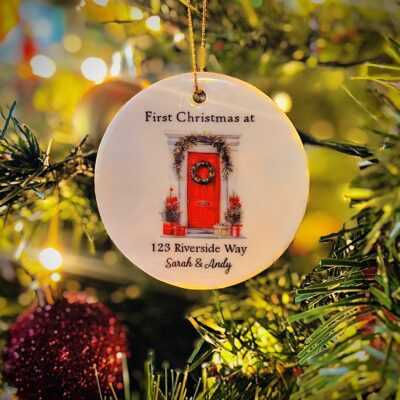 Photo of an example personalised ceramic Christmas decoration for a new home hanging on a Christmas tree.