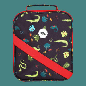 In front of a teal background: a black lunch bag with imagery of dark teal and green lizards amongst various leaves and plants of the jungle.