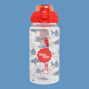 In front of a cornflower blue background: a kids' water bottle with imagery of sharks and various tropical fish in front of waves of various shades of blue.